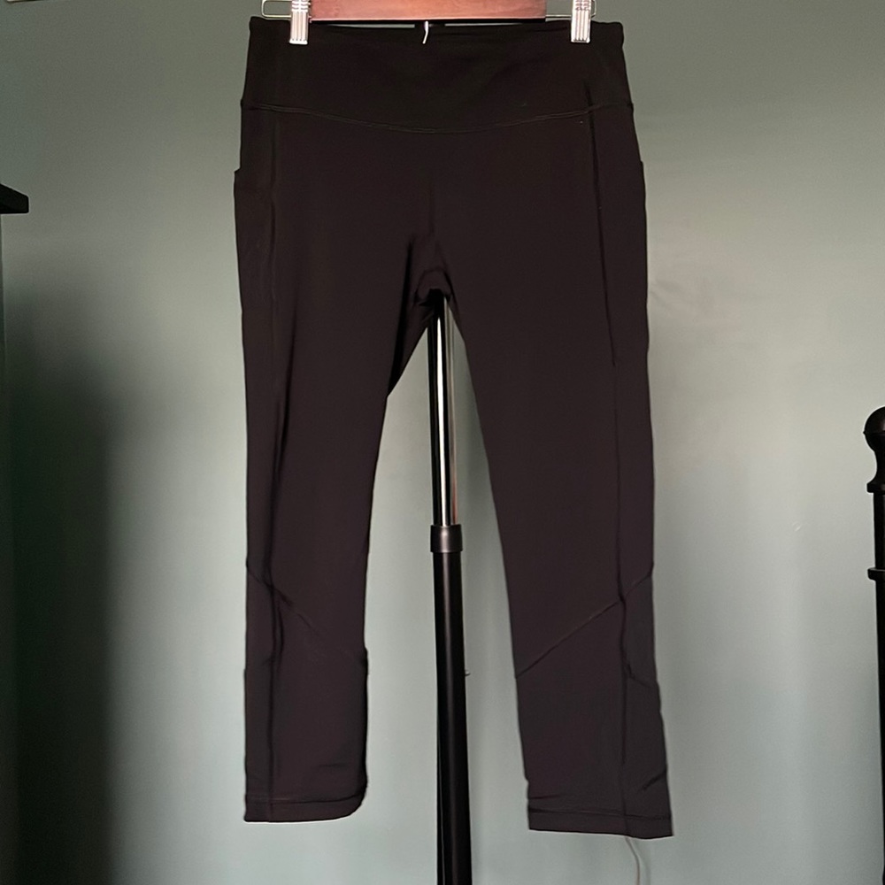 Lululemon black capris leggings with mesh on calves. Zippered back pocket.